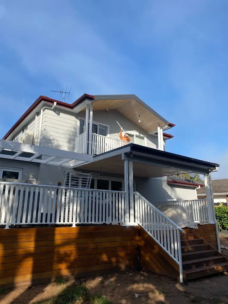 Completed two-storey facade, alfresco deck with white railings and pergola